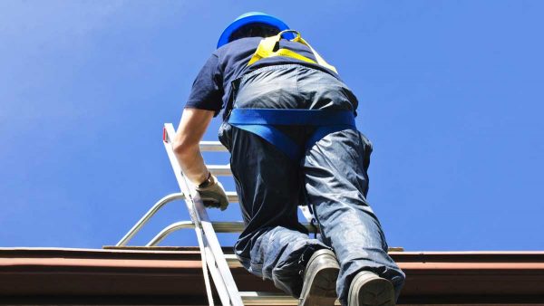 Roofer climbing on roof