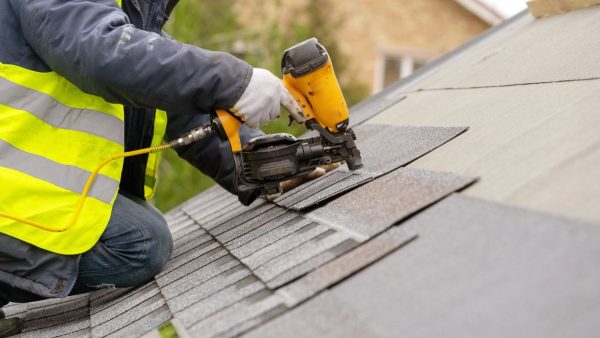 Roofer with nail gun