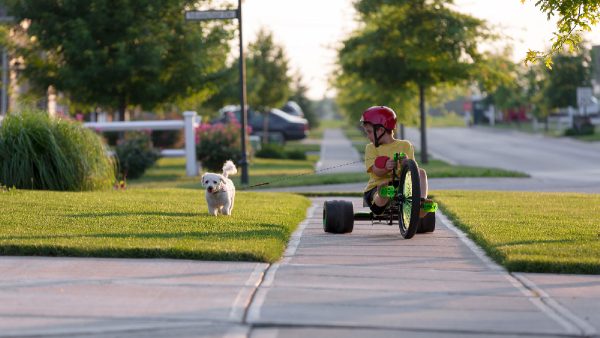 Child playing in well maintained neighborhood